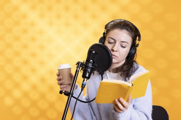 individual reading book into a microphone