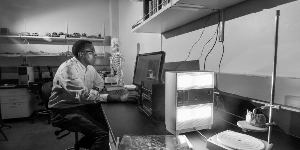Photo of faculty member Charles Musiba in the lab