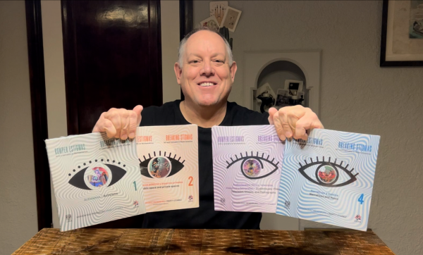 professor marty otanez holding his books