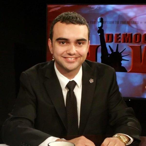 Simon Maghakyan seated at a desk.