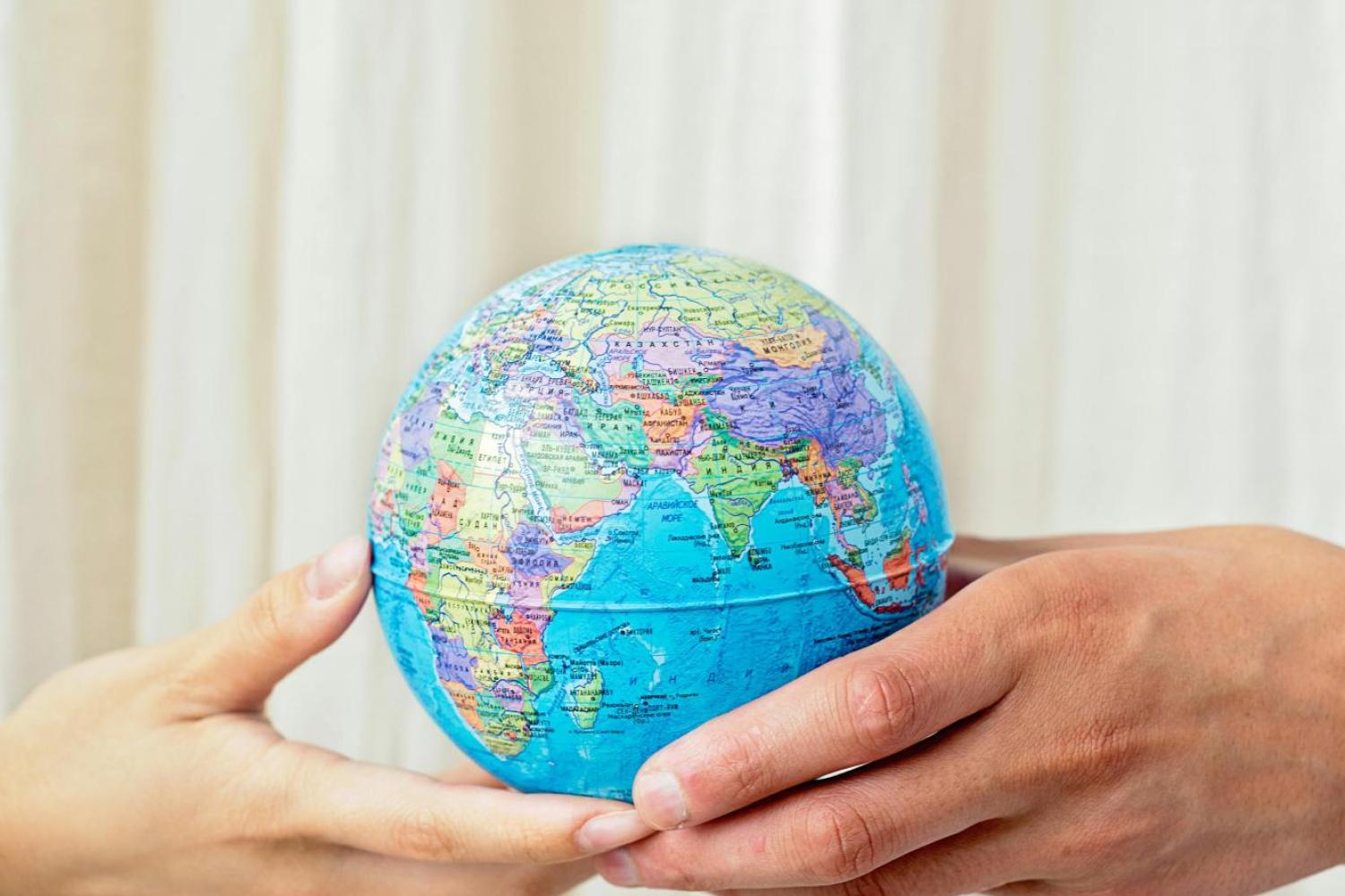 Two people holding Globe