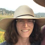 Yael with a tan hat on smiling
