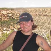 Helena standing in front of canyon with hat on