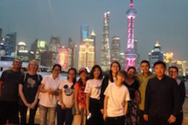 Photo of students in front of Shanghai skyline
