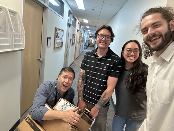 SJH, Sam Harris, Grace Truong, and Jacob Johns in a group picture taken place in the COMM hallway