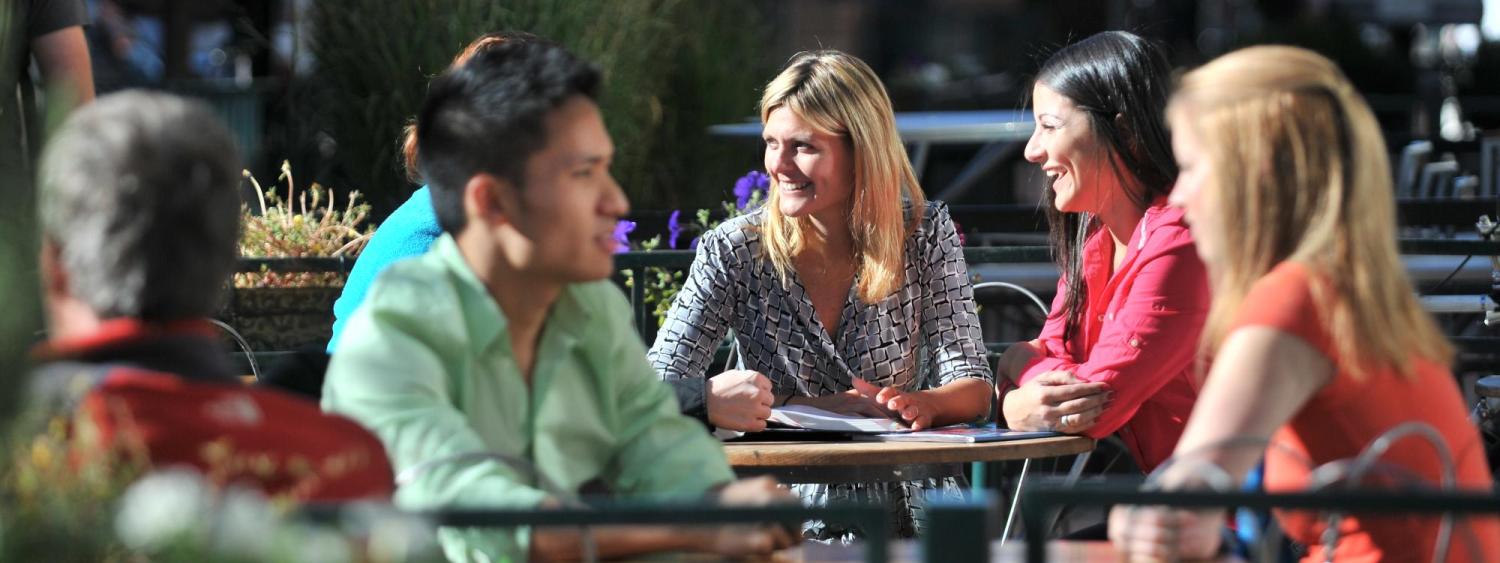 Photo of students outside talking with faculty
