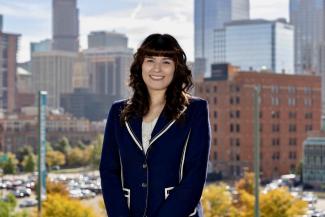 Head shot of Valerie Ortega with Denver as the background.