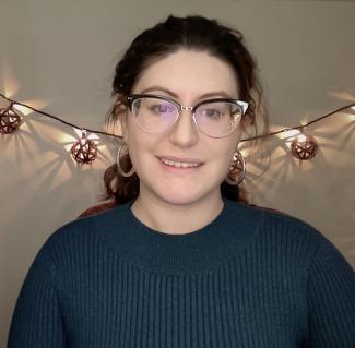 Head shot of Anne, Glasses, Blue Shirt