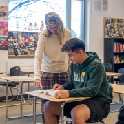 CU Succeed Teacher Jami, and Rolando sitting at a desk