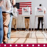 people standing in line to vote at a voting booth