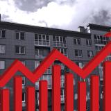 black and white apartment building with red arrow pointing up
