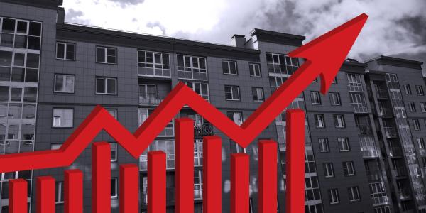 black and white apartment building with red arrow pointing up
