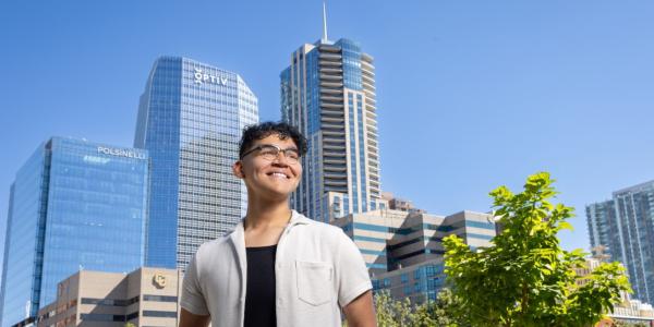 William with the Denver skyline in the background