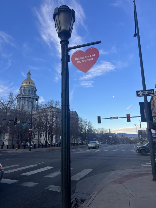 Heart shape hoisted on a lamppost saying Clas Cares at CU Denver