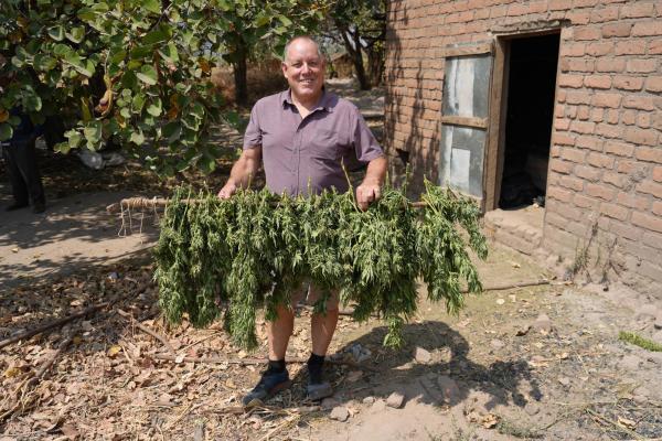 Dr. Otañez holding plants outside