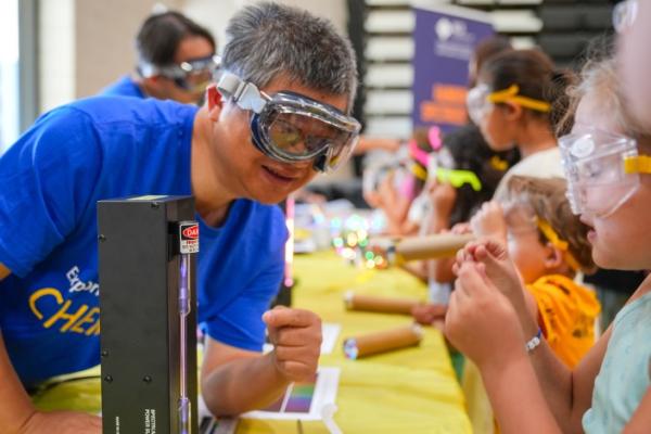 chemistry professor doing an experience while children look on