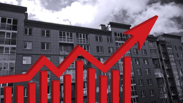 black and white apartment building with red arrow pointing up