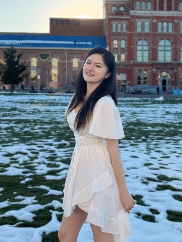 Junfei Liu, Winner of CLAS Fall 2024 Outstanding BA, stands in front of the Tivoli on the Auraria Campus