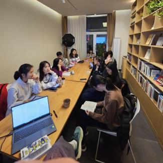 students and faculty having a discussion in a book club in Beijing, China