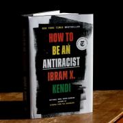 Ibram Kendi's book How to be an Antiracist standing up and partially open on a table.