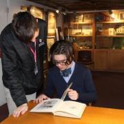 a teacher stands over a student at a desk