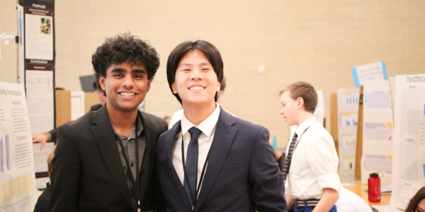 two boys smiling at science fair