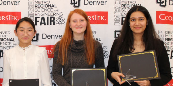 three girls holding science fair awards