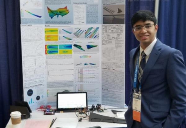 Krithik Remesh with poster board at 2018 ISEF Competition 