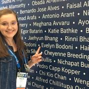 Evelyn Pointing at Her Name at the 2018 ISEF Registration
