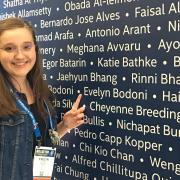 Evelyn Pointing at Her Name at the 2018 ISEF Registration