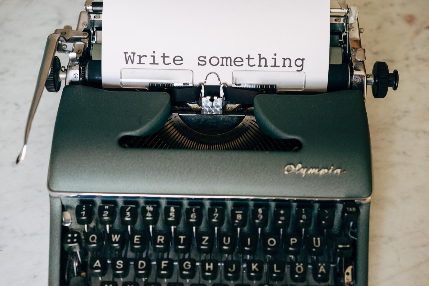 Typewriter with words "write something" typed on the paper