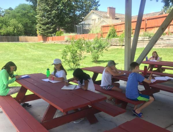 Cherry creek writers working at a picnic table