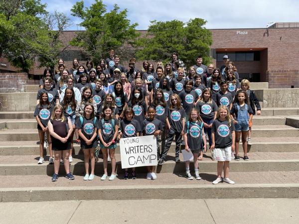 Young writers standing on stairs outside of Plaza building on Auraria Campus