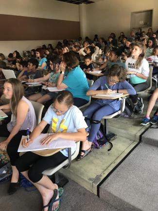 Cherry Creek campers writing at desks