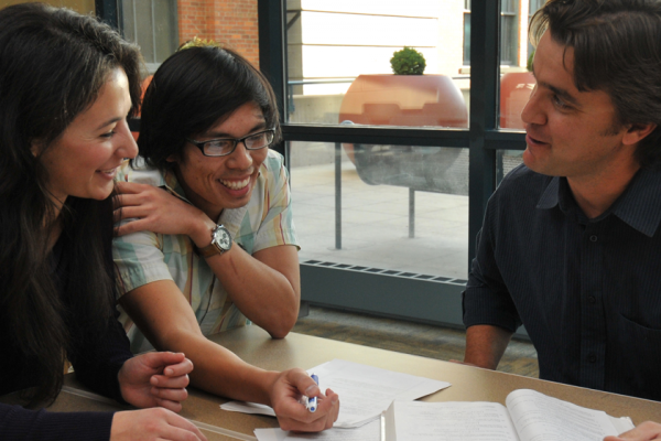 Students consulting with professor