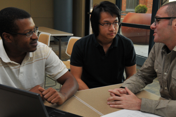 Students consulting with Professor Hani Mansour