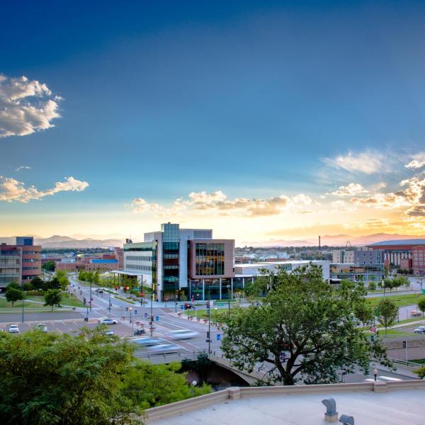 A wide shot of Auraria Campus with the Rocky Mountain sunset in the background