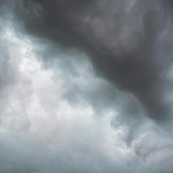 Dark, heavy storm clouds fill the sky, suggesting incoming rain or severe weather.