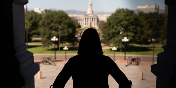 A woman in downtown Denver stands on capitol hill
