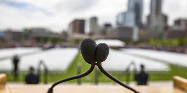 A close-up of a microphone set at the CU Denver commencement ceremony