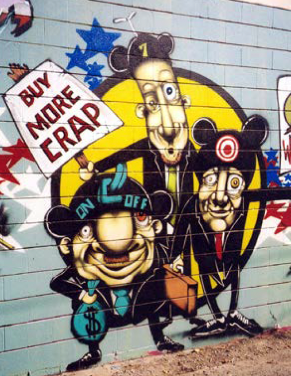 A graffiti art installation of cartoon men holding a sign that reads "Buy more crap."