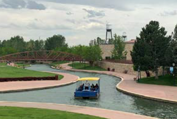 A ferry carrying tourists on a trip down the Pueblo Riverwalk.