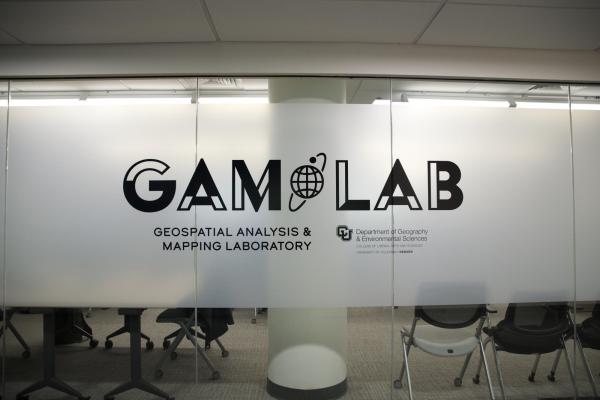 GAM Lab logo on a glass wall of the laboratory. 