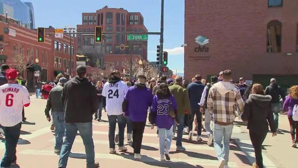 Fans walk along 20th Street in Denver toward Coors Field.