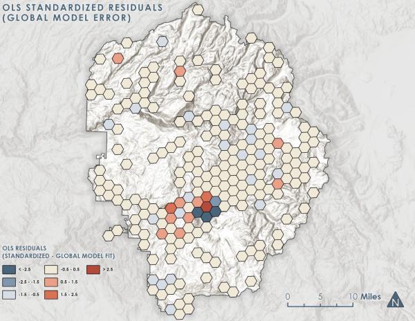 Hexagonal bin map of Yosemite National Park showing OLS standardized residuals from a global regression model, with blue hexagons indicating underprediction and red-orange indicating overprediction, clustered in the south-central area of the park.