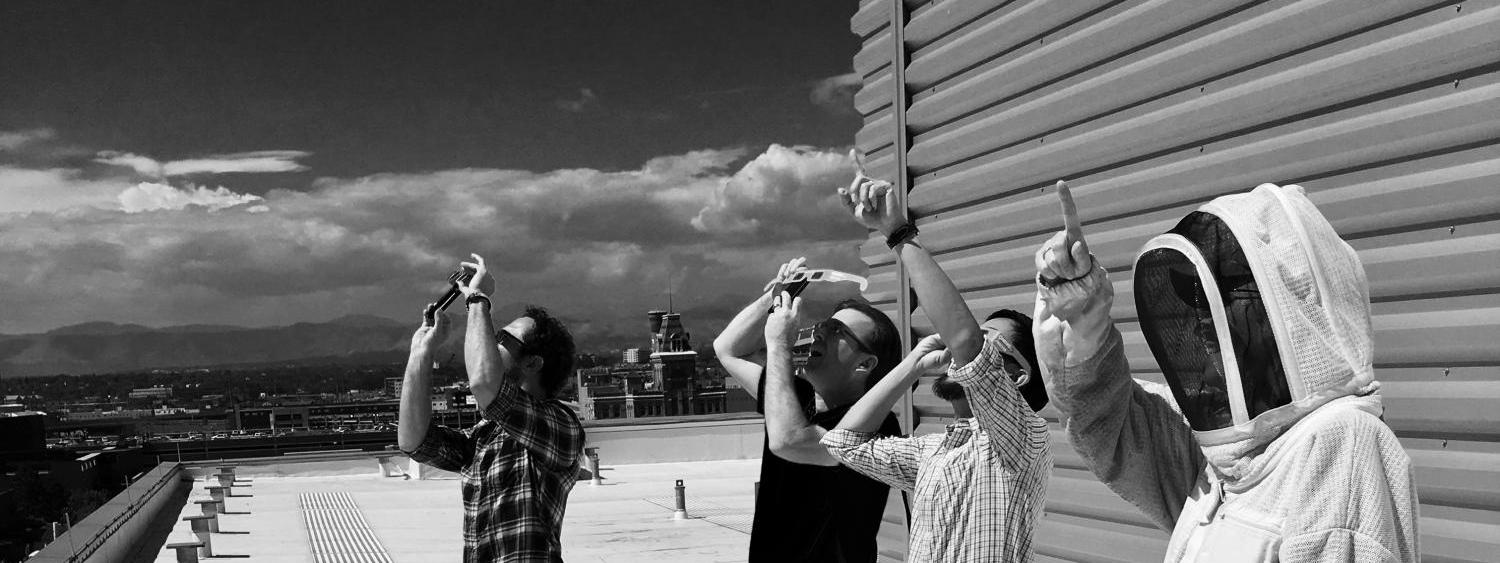 Faculty observing the 2017 Solar Eclipse on a rooftop