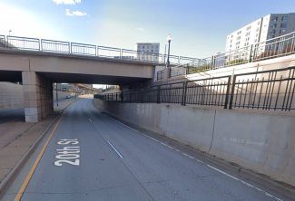 20th Street passing under an overpass bridge near Little Raven Street in Denver, Colorado.