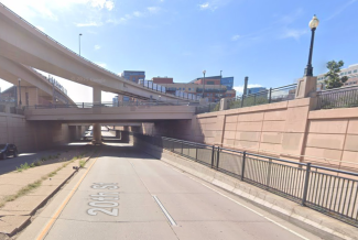 20th Street passing under a stack of highway overpasses near Wewatta Street in Denver, Colorado.