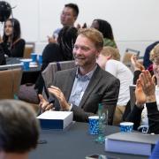 Ben Crawford at the Faculty Excellence Awards clapping with other faculty.