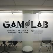 GAM Lab logo on a glass wall of the laboratory. 